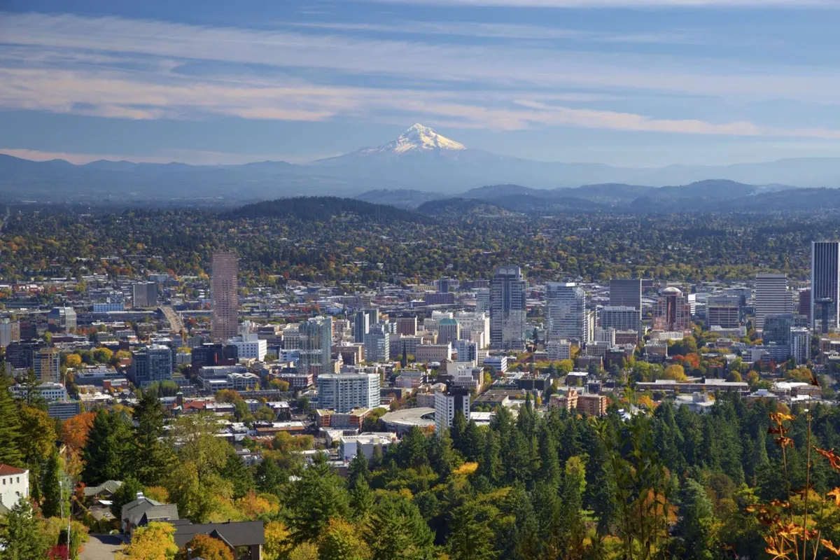 A panoramic view of the downtown skyline with Mount Hood in the background and colorful fall foliage. The image suggests opportunities for sightseeing, urban excursions, and appreciating natural beauty—all within easy reach.